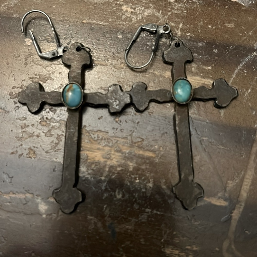 Cross earrings gently worn with turquoise stone.
